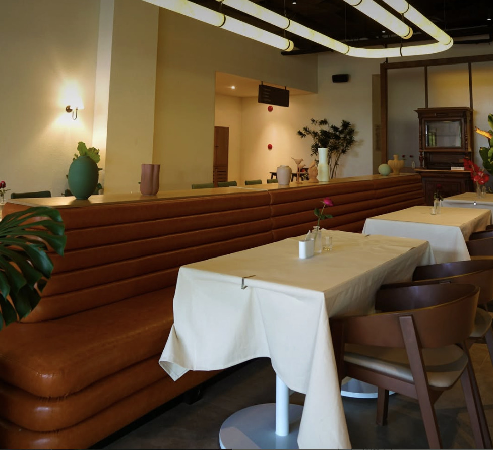Écoute dining room banquette with warm leather seating and softly lit tables